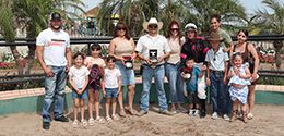 The winning connections of RM Dulce Valiente accept the $45,550 AQRA Presidents Open Spring Derby trophy at Turf Paradise on Monday.