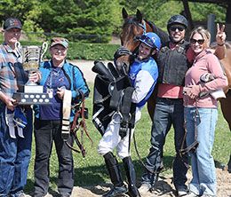 The winning connections of Had To Be Fabulous accept the OQROOI Bonus Futurity stakes trophy at Ajax Downs.
