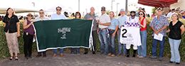The connections of Effortless Favorite accept the All American Juvenile winning trophy at the Downs at Albuquerque on Monday.