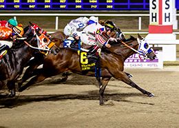 Atta Boy Slim Louisiana winning the Champions Day Juvenile. em>