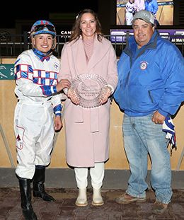 The winning connections of Relentless Legacy accept the Cash Caravan Stakes trophy at Canterbury Park on Saturday.