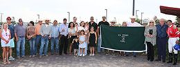 The winning connections of Solid accept the 167,171 Zia Derby [RG2] trophy at the Downs at Albuquerque on Saturday.