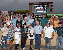The winning connections of Jess Rocket Man accept their sixth Bob Morehouse Stakes trophy at Canterbury Park Wednesday night.