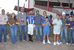 The winning connections of Hasten accept the Zia Quarter Horse Futurity stakes trophy.