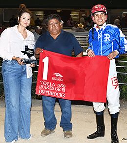 The winning connections of Embers Time accept the $56,000 TQHA 550 Stakes-G3 winning trophy on Friday at Retama Park.