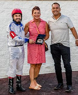 The connections of Dropping Dimes accept the Treme Derby winning trophy at Delta Downs on Saturday.