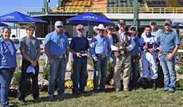 The winning connections of Mystic Paint accept the Adequan Will Rogers Derby Challenge stakes trophy at Will Rogers Downs.