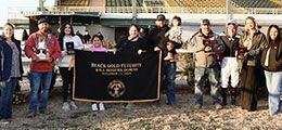 The winning connections of Ivory Macho Man accept the Black Gold Futurity Championship trophy.
