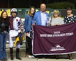 The Nellesens accept the Kindergarten Futurity stakes trophy from Shonna Smith and Brenda Figueroa.