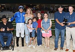 The winning connections of Ontherocks accept the TQHA 550 Stakes trophy.