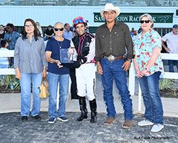 The winning connections of Eye Will Decide accept the $55,000 Jesse Yoakum Memorial 870 Stakes trophy on Saturday at Sam Houston Race Park.