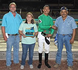 Owners Jamie and Wendy Howard, jockey Cordarelton Benn and trainer Luz Chavira accept the $14,000 Tulsa State Fair Stakes trophy at Fair Meadows on Saturday.