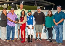 The winning connections of One Fast Cajun accept the $35,000 Races and Aces trophy at Evangeline Downs on Saturday.
