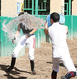 The other jockeys celebrate after Abel Lara scored his first career victory at Turf Paradise on Wednesday.