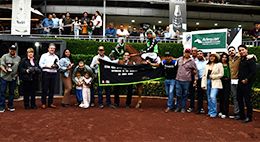 The winning connections of Phillybuster accept the Adequan Derby Challenge trophy at the Hipodromo De Las Americas on Sunday.