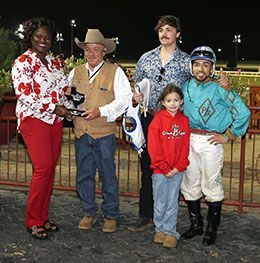 The winning connections of First Time For Wine accept the Yellow Rose of Texas Stakes trophy at Lone Star Park.