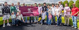 The winning connections of Di Kvn Waven accept the $346,566 Louisiana Downs Futurity [G2] trophy at Louisiana Downs on Saturday.