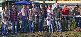The winning connections of R Cowgirl accept the $15,728 Don Drake Memorial Stakes trophy at Will Rogers Downs on Sunday.