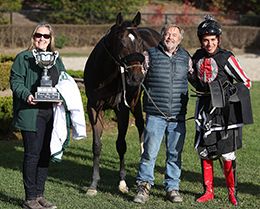 Trainer Rick Kennedy and jockey Christian Benitez accept the $41,916 (US) Ontario Sires Stakes Derby trophy at Ajax Downs on Monday.