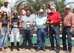 The winning connections of Scoops Dynasty accept the AQHA Turf Paradise Championship Challenge stakes trophy at Turf Paradise.