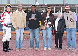 The winning connections of Flashtoglory accept the $90,000 Lou Wooten and Sydney Valentini Stakes trophy at Sunland Park on Sunday.