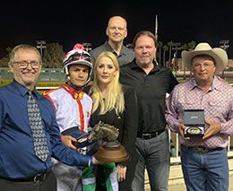 Chris Wade presents the winning connections of Streaks Of Power-lessee Robert Tyburski and owner-breeder Ken and Nina O'Brien, trainer Monty Arrossa and jockey Armando Cervantes the Cox Ranch California Distaff Challenge stakes trophy.