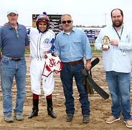 The winning connections of Mr Booombastic accept the Mari Hulman George Overnight Stakes trophy at Horseshoe Indianapolis.