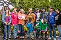 The winning connections of Feature Prospect accept Winners Circle Church Stakes trophy on Friday at Louisiana Downs.