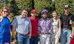 The winning connections of Captain Eagle accept the Louisiana Maiden Classic stakes trophy on Saturday.