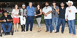 The winning connections of Jess Kissing Beau accept the $57,500 Miss Retama Stakes trophy at Retama Park on Friday.