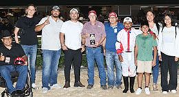 The winning connections of Tempting Alibi accept the TQHA 250 Stakes trophy.