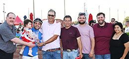 The winning connections of Kwick Fast Prize accept the Iowa Stallion Futurity stakes trophy at Prairie Meadows.