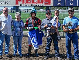 The winning connections of Eyez On Corona accept the Adequan Grants Pass Derby Challenge stakes trophy.