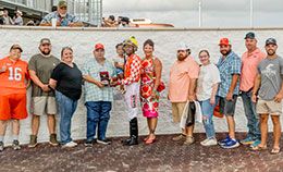 The winning connections Explosive Legend accept the Live Oak Stakes trophy at Delta Downs.