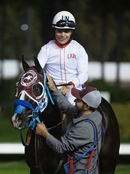 Jockey Jose Nicasio returns to the winner's encloser aboard Los Alamitos Winter Derby winner Brown Coffeee.