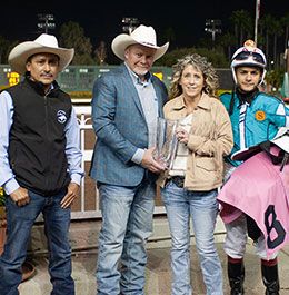 Ramiro Castillo, Travis and Wendy Saxton, and Armando Cervantes accept the Ah Sigh Handicap stakes trophy at Los Alamitos Race Course.