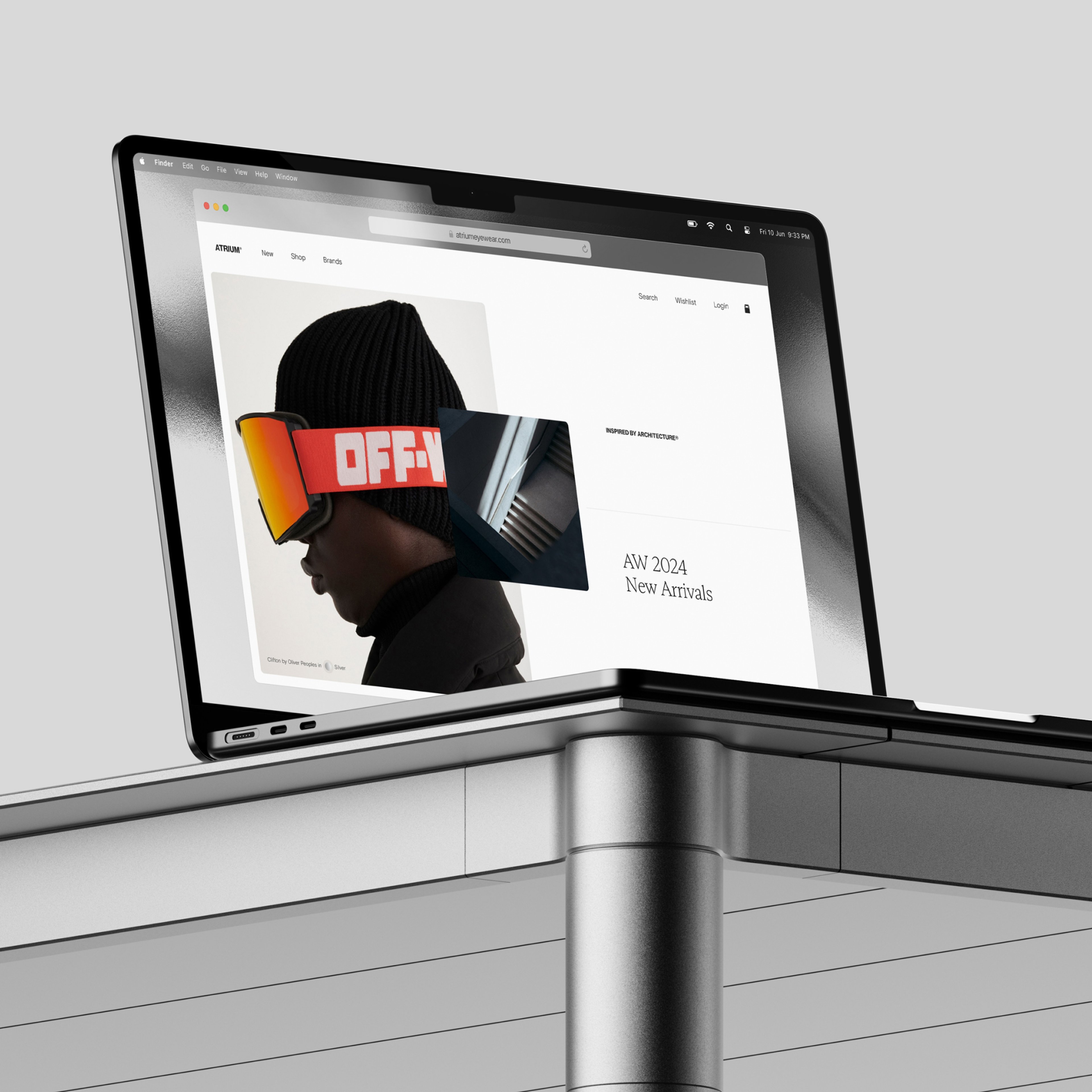 Macbook sat on desk showing the Atrium ecommerce site.