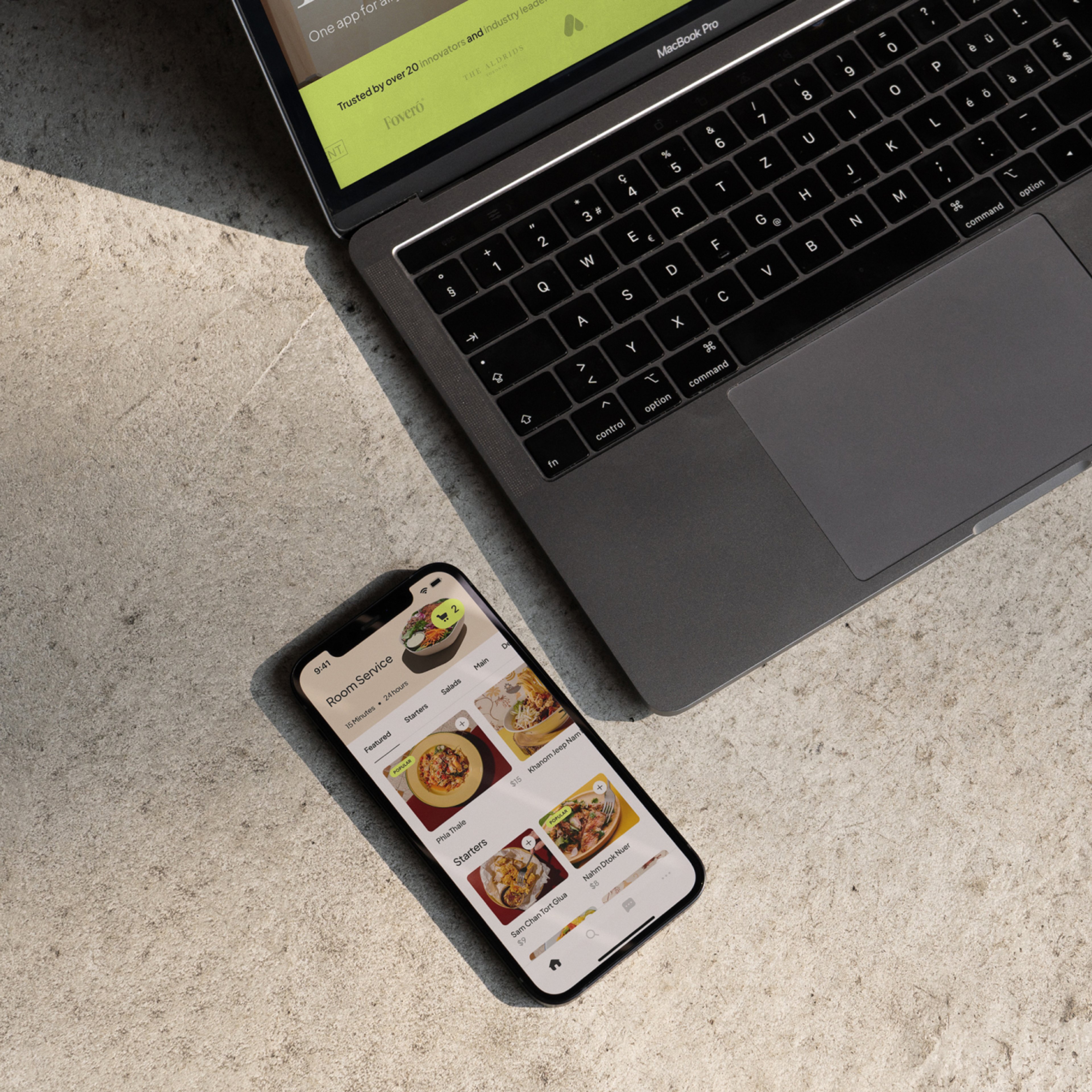 Image of a Macbook and iPhone displaying the Loft website and app