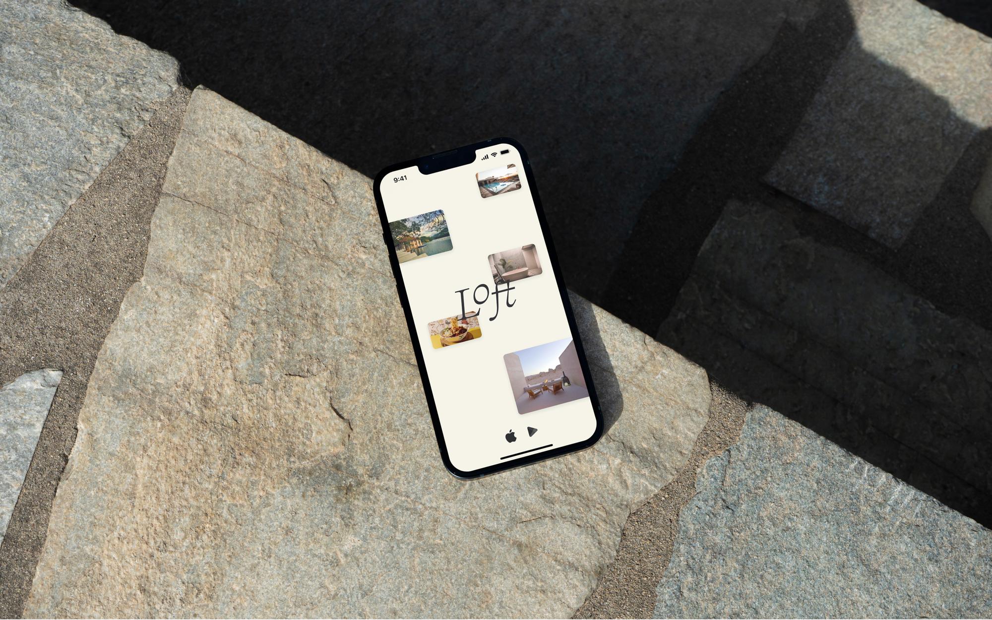 iPhone and Macbook on a concrete surface displaying the room service ordering page and homepage from the Loft project