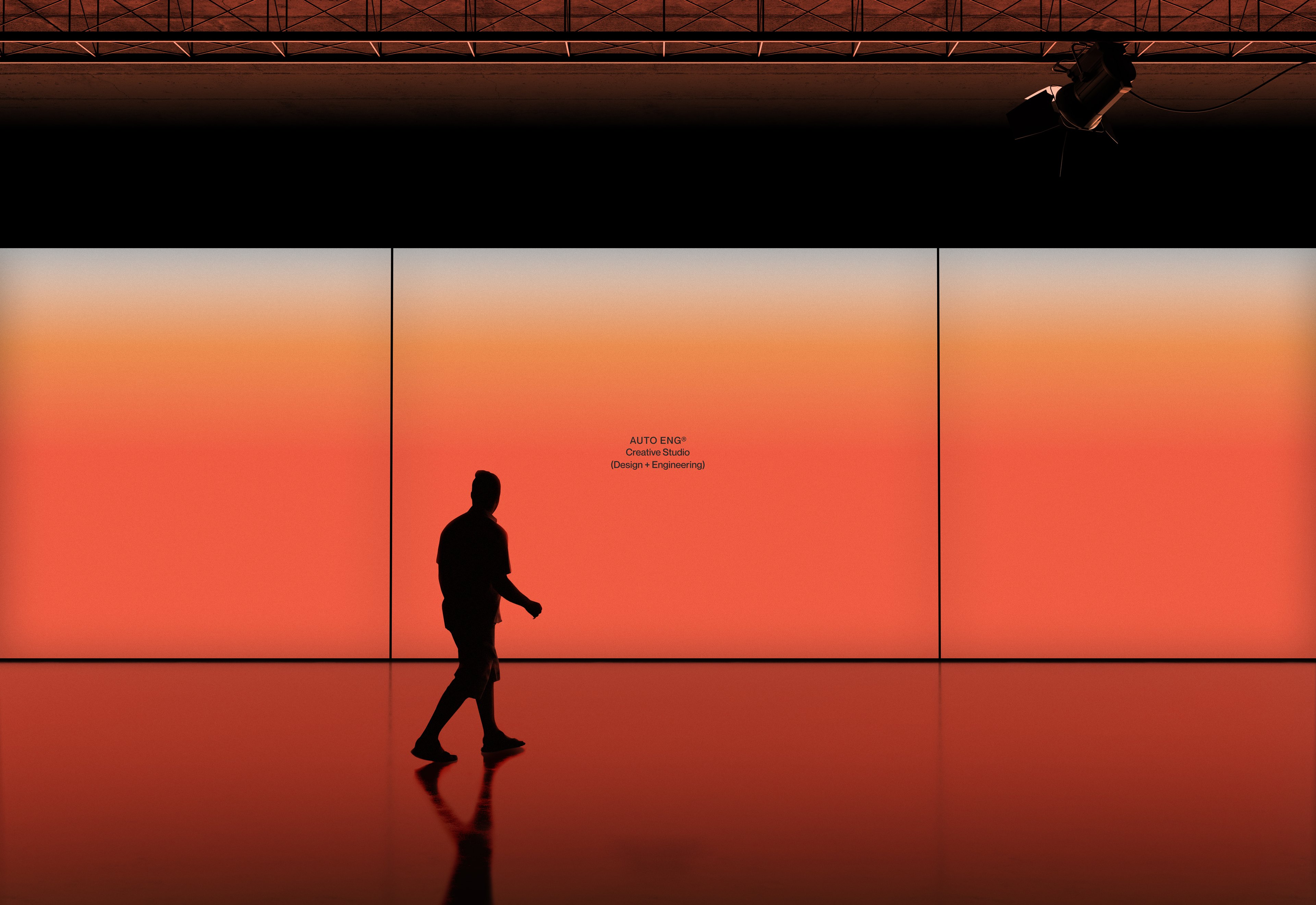 Person walking in front of a large orange LED screen displaying the Automatic Engineering logo