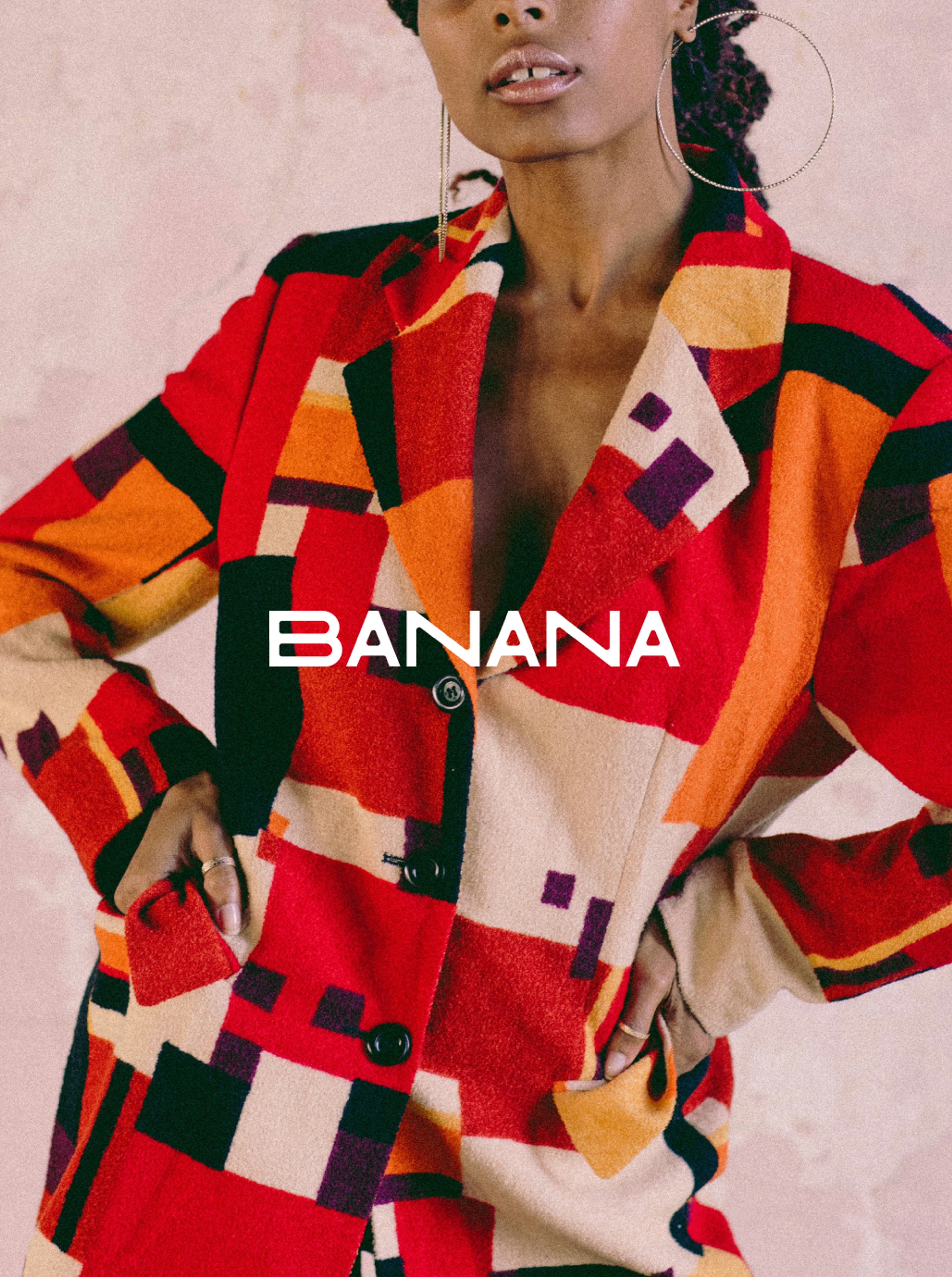 Woman wearing a brightly coloured patchwork jacket. "Banana" logo is centred on top of the image.