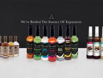 Al-Chemy product line with variety of bottles and advertisement reads "We've Bottled the Essence of Enjoyment"