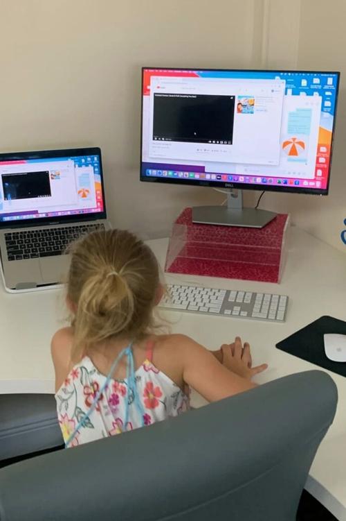 Young female child using computer in office