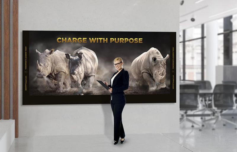 Woman standing in front of banner that has rhinos charging