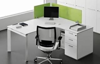 White office desk with monitor and green privacy walls
