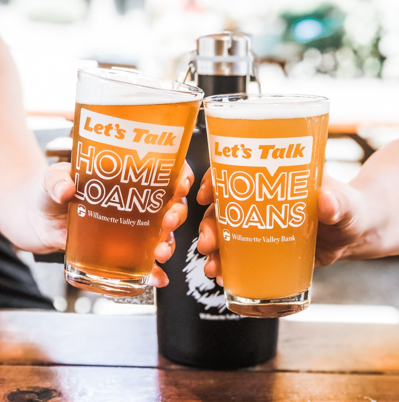 Branded pint glasses with screen-printed company slogan in white.