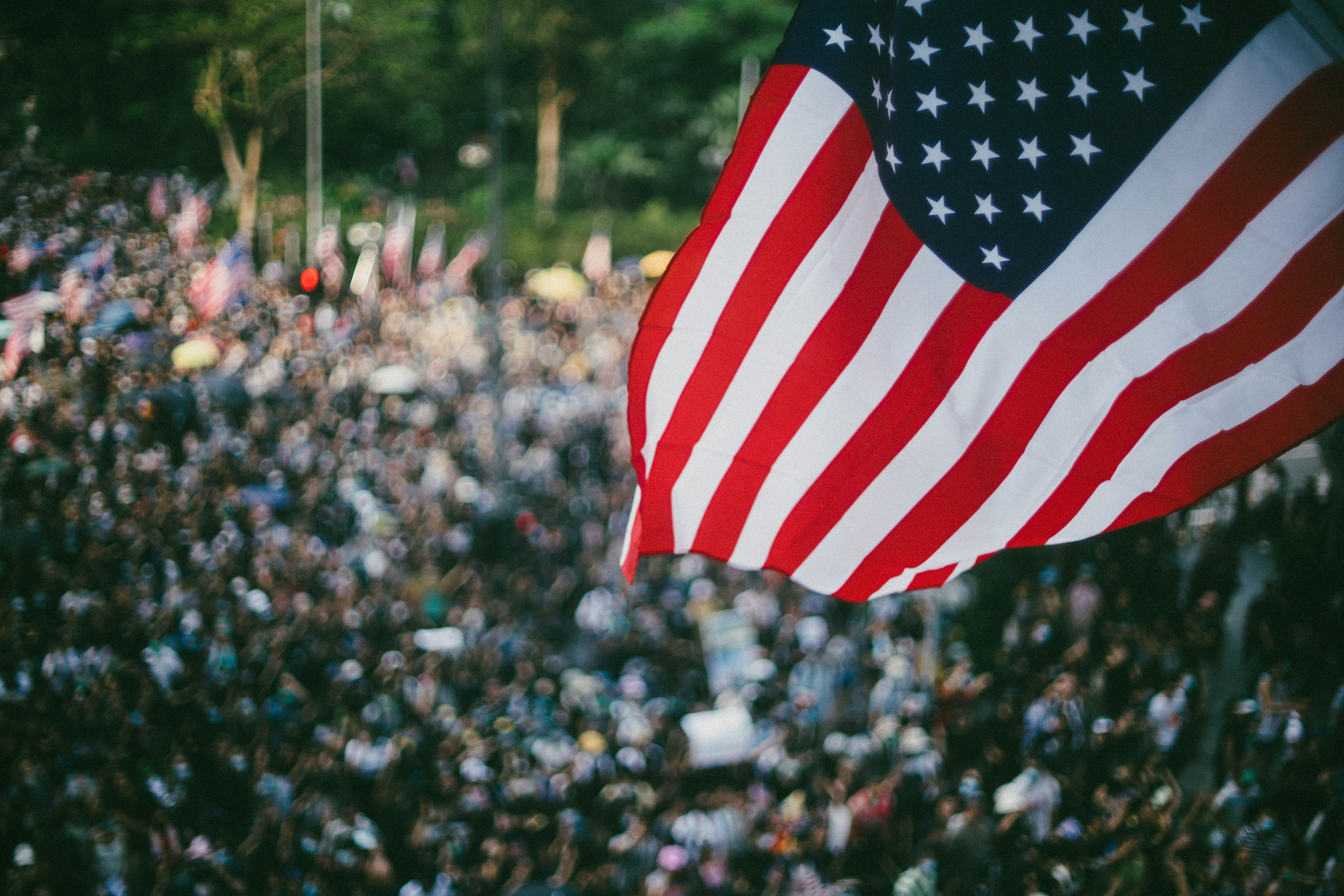 Thousands of protesters waving US flags