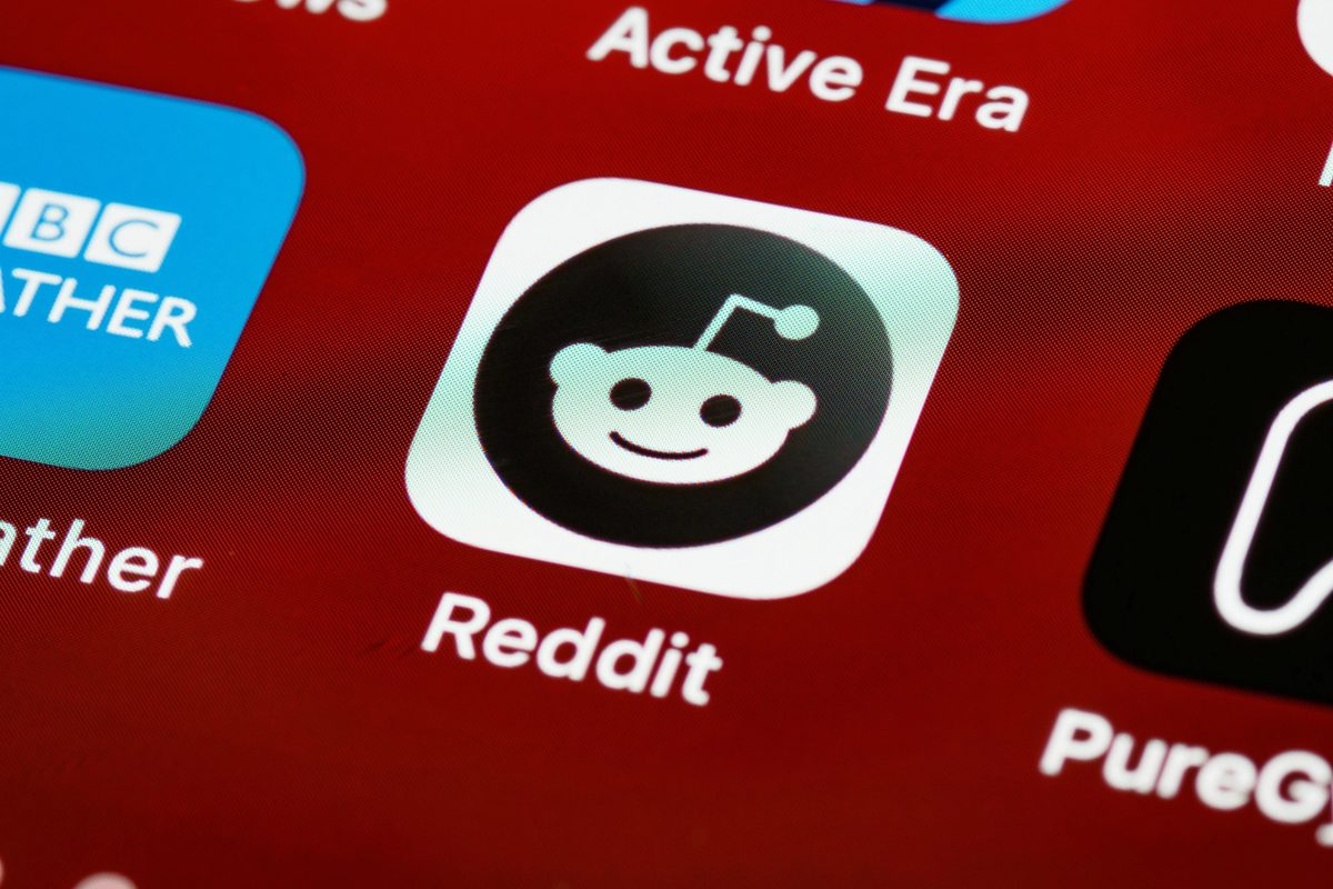 Reddit app icon on a cell phone