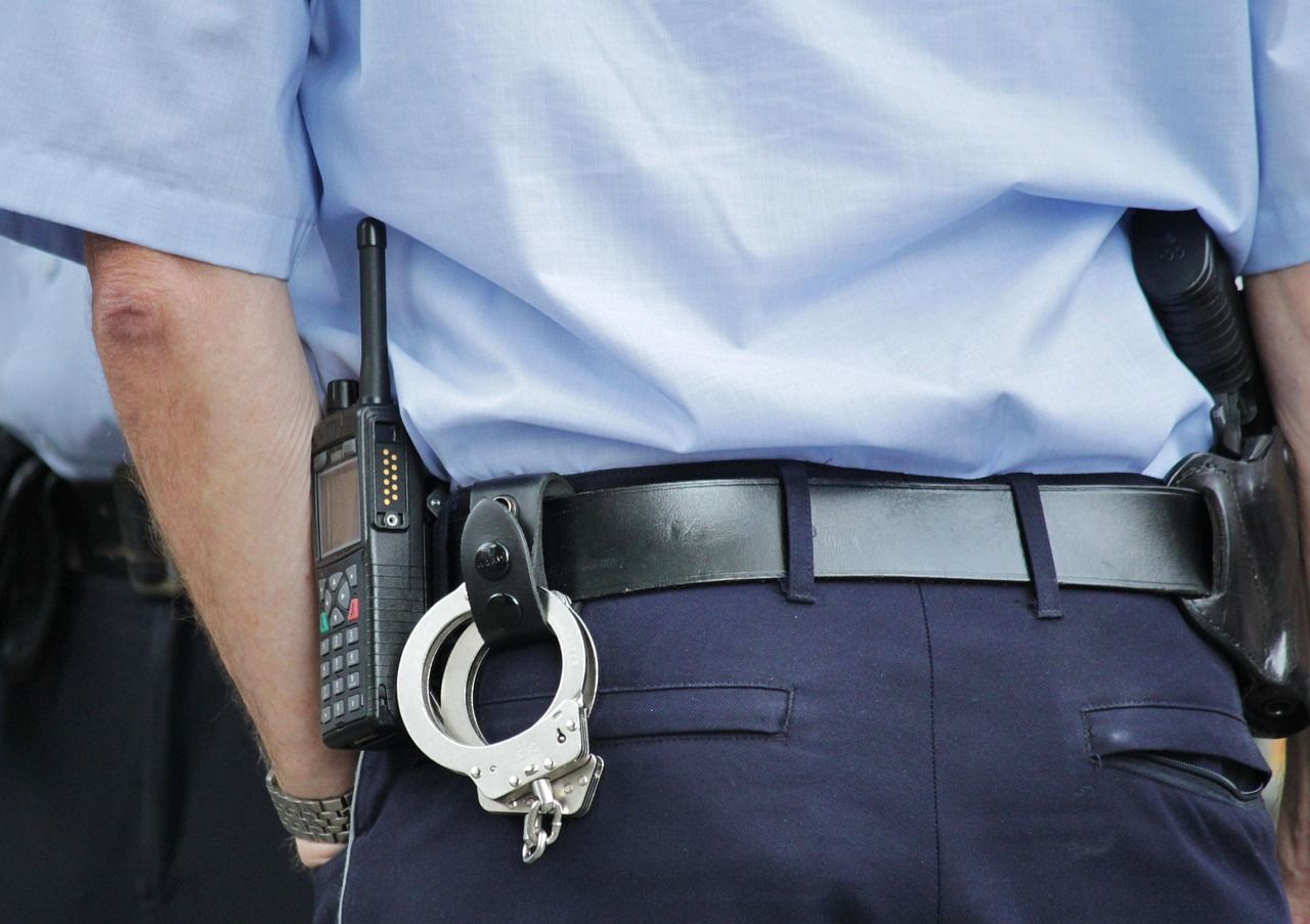 Police officer with handcuffs on his belt line