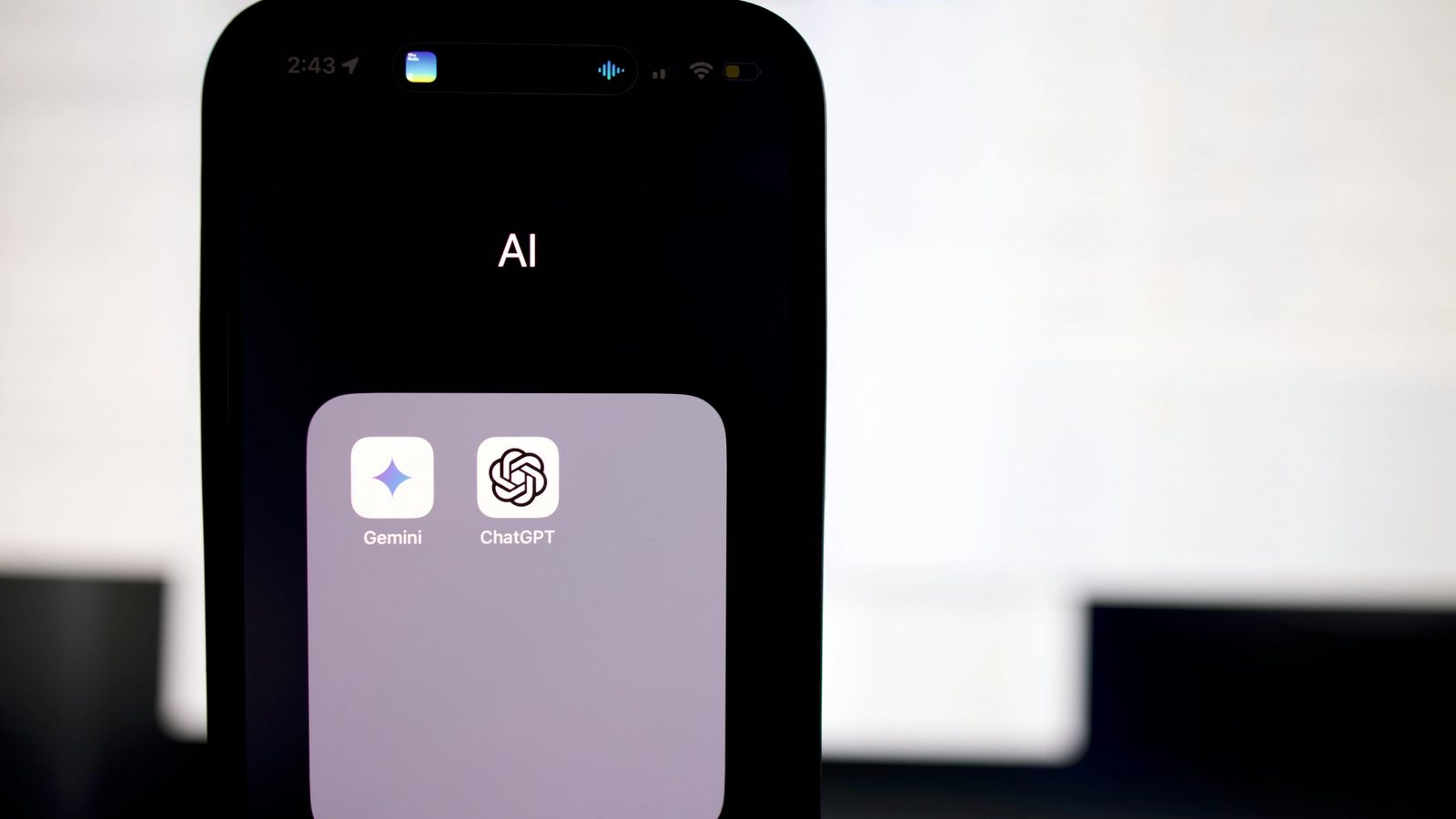 Main Image: A phone with an AI button that contains two apps - Gemini & ChatGPT